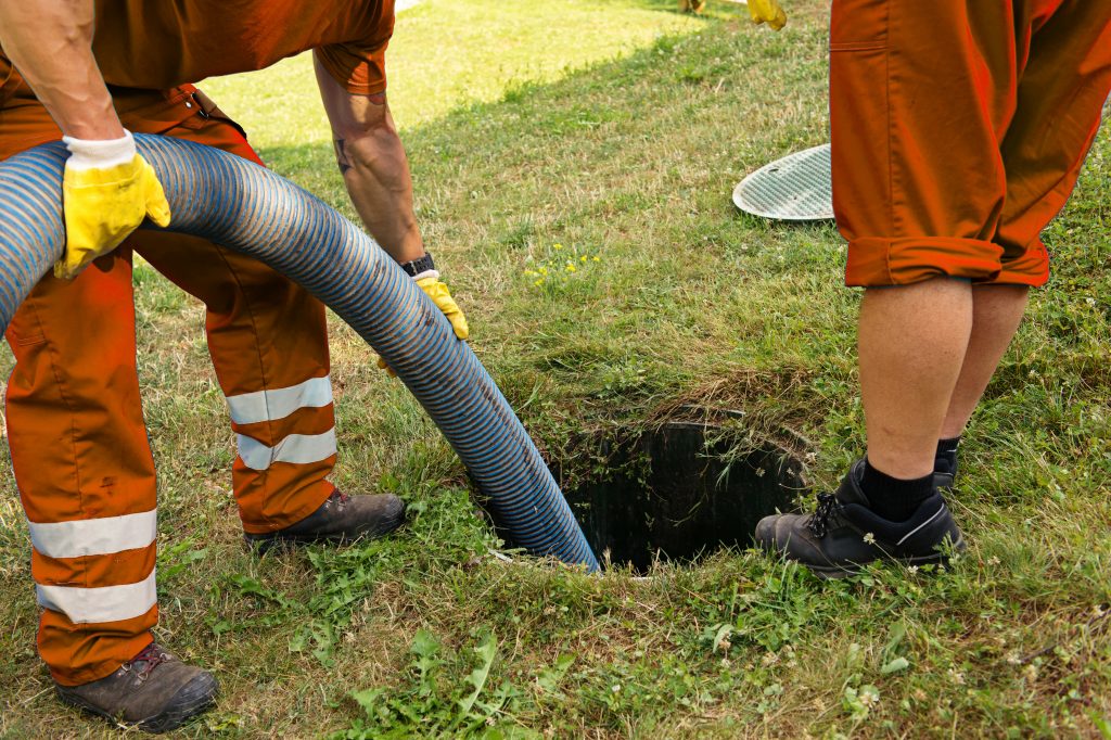 Emptying household septic tank. Cleaning and unblocking clogged drain.