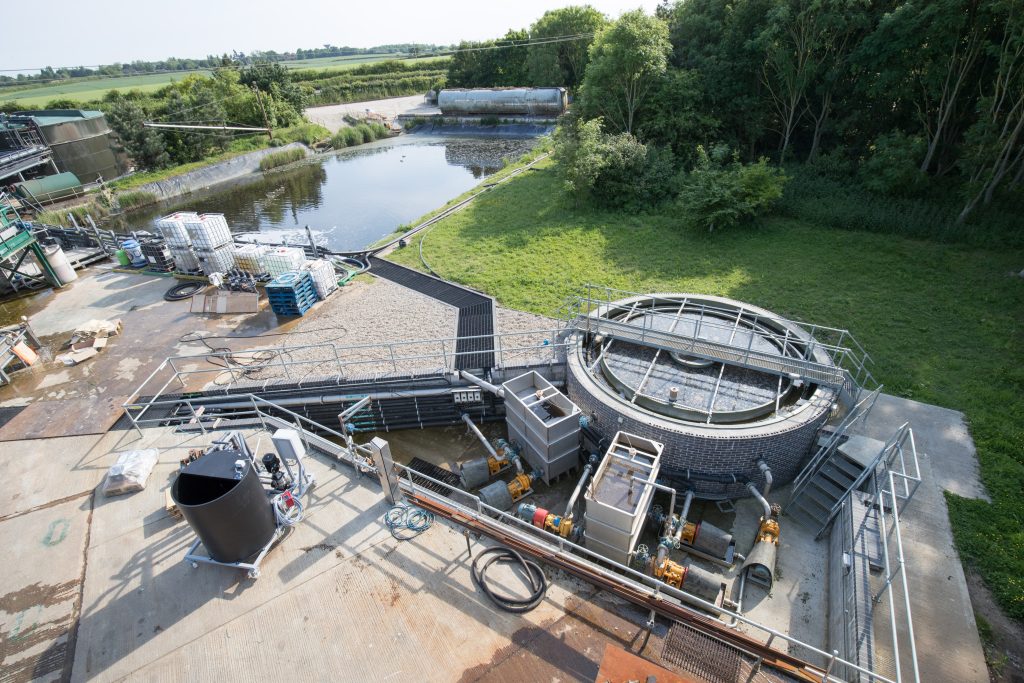 Aerial view of a wastewater treatment facility with a pond