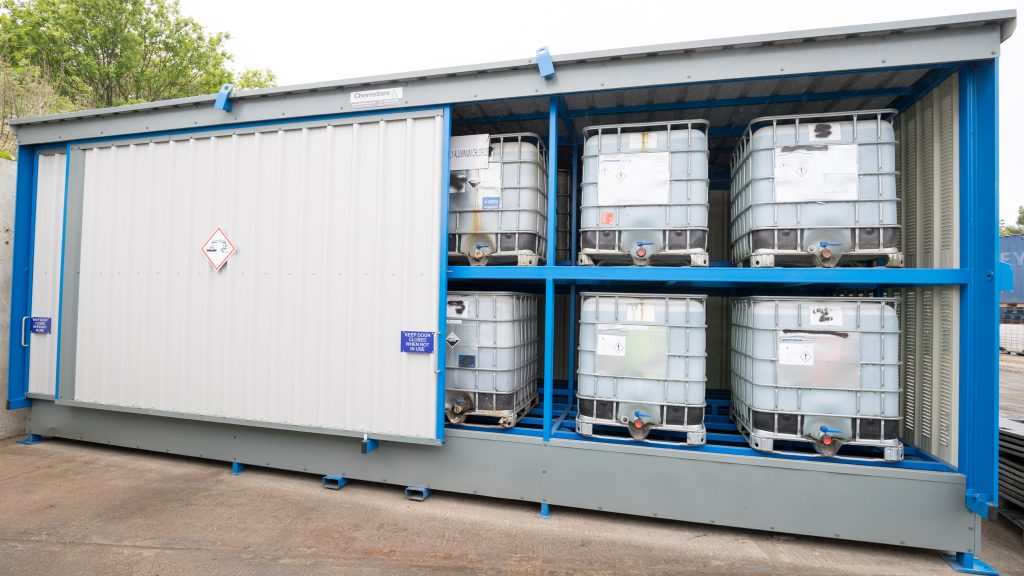 Container with sliding door filled with chemical tanks | M Gaze & Co. Ltd